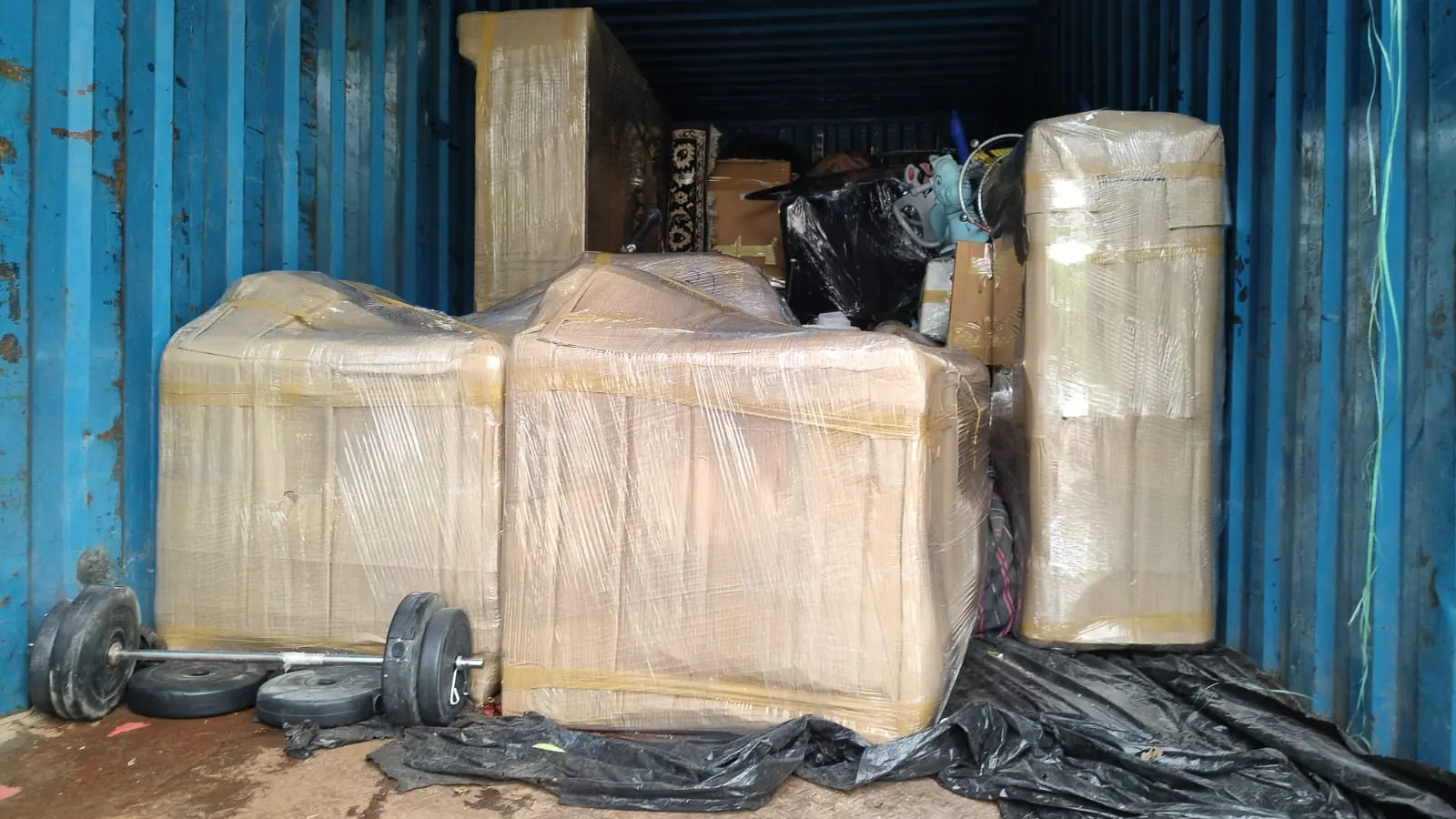 Household goods loaded in a closed container truck in Gurgaon