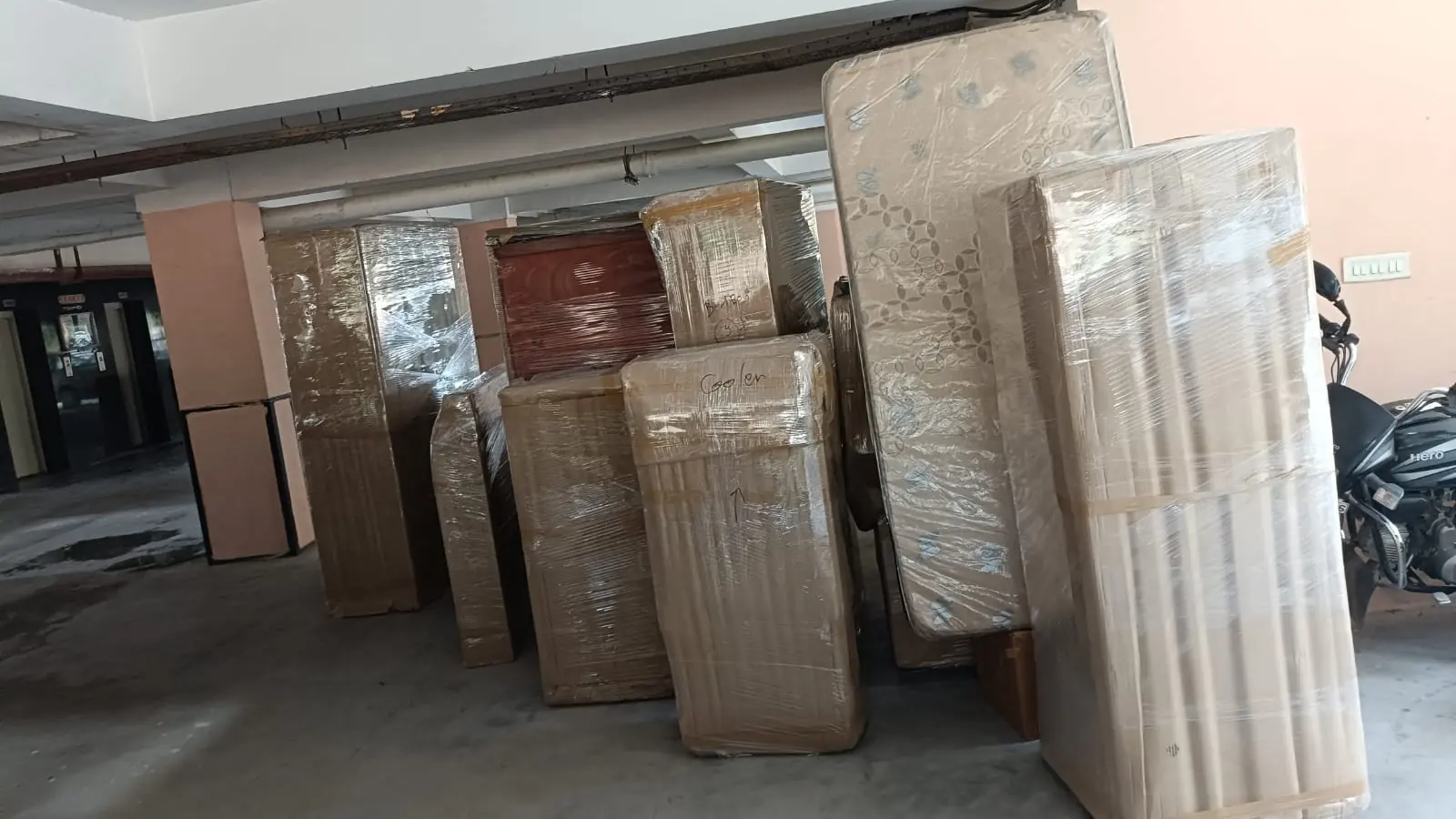 Om Packers team loading packed household goods for home shifting in Gurgaon